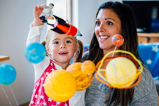 imaginative little girl and her rocket - earth globe mother child imagens e fotografias de stock