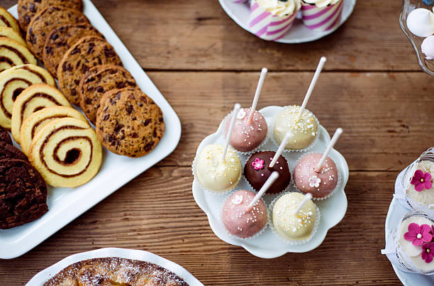 istock Table with cakepops, cookies and cupcakes. Wooden background. 625755636