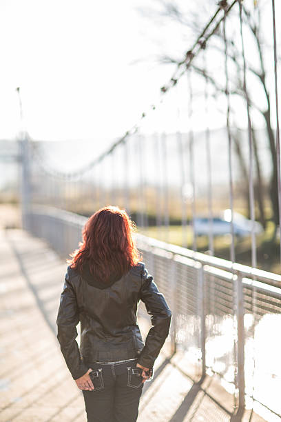 istock woman passes a footbridge 625757218