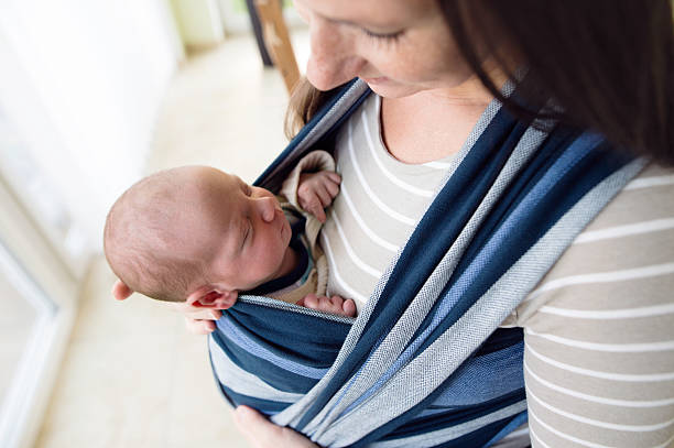 istock Close up, beautiful mother carrying her son in sling 625758314