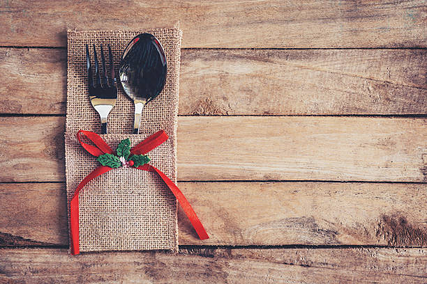 istock christmas table place setting and silverware on wood with space. 625758484