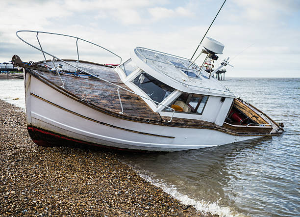istock sinking boat on a beach in distress 625759866