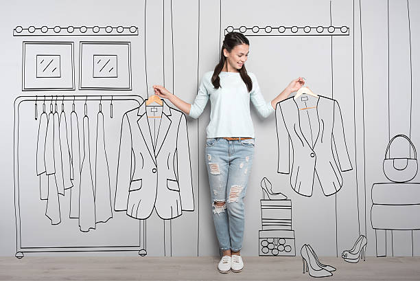 istock Happy woman holding clothes on hangers 625759928