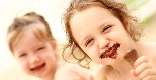 istock Girls eating ice cream on beach 625769018