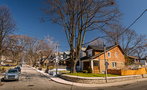 Toronto urban neighbourhood Typical family house neighbourhood in downtown Toronto. Fall season, no leafs on the trees, sunny day. city street street corner tree stock pictures, royalty-free photos & images