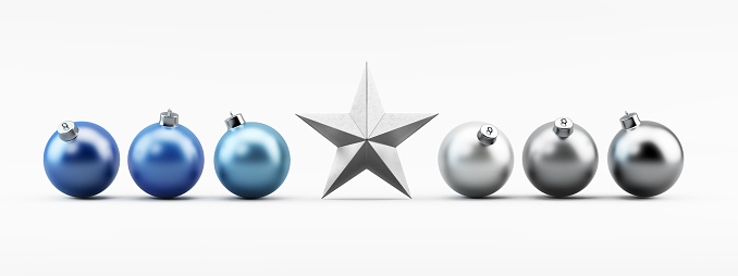 Silver and blue  colored chrsitmas bauble ornaments are standing on white with a silver christmas star. Christmas ornaments are isolated on white background. Clipping path for christmas baubles and tree topper  are included. Great use for christmas related concepts. Horizontal composition with copy space. Front view.