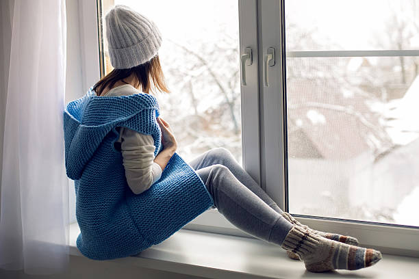 istock girl in a white hat and blue vest is sitting 625772244