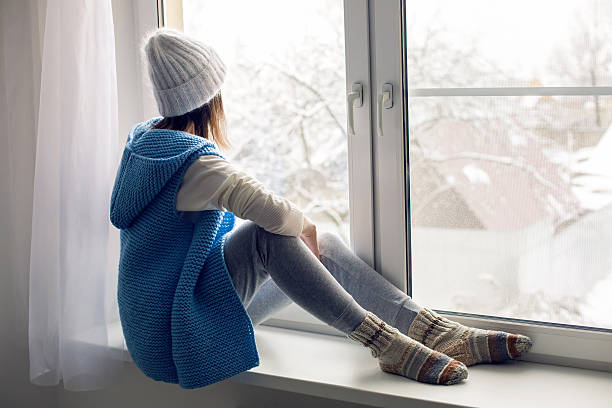 istock girl in a white hat and blue vest is sitting 625772312