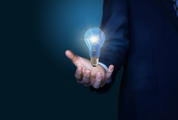 istock Bright idea in hand Business man 625773088