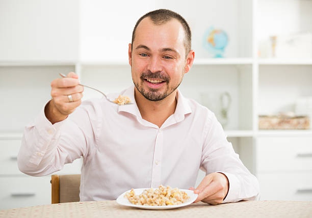 istock Positive young man eating porridge 625773120