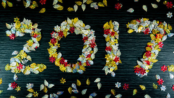 istock happy new year 2017 with colourfull bokeh black colour  backgrou 625773708
