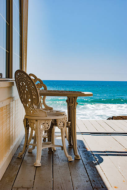 istock wrought iron table and chairs on wooden deck 625773824