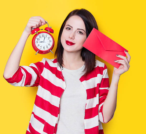 istock girl with retro alarm clock 625774600