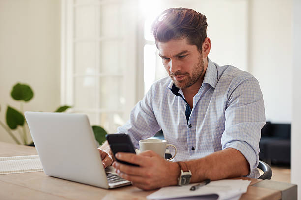 istock Young man working with laptop and mobile phone 625780282