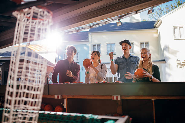istock Young people shooting hoops at amusement park 625780462