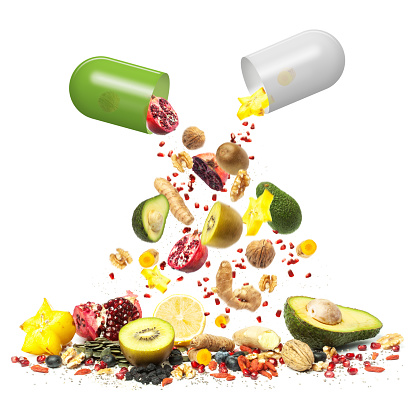 Superfood can be Medicine, composition with a collection of superfoods falling out of pill capsules