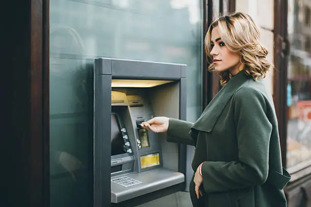 Young woman using a cash machine