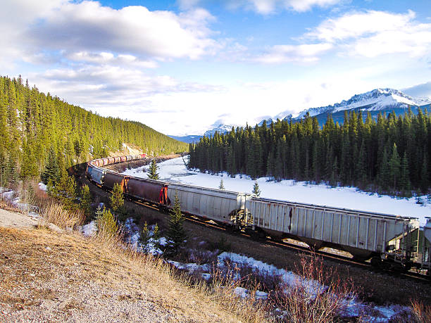 istock Freight Train along Bow River in Winter, Canadian Rockies 625783198