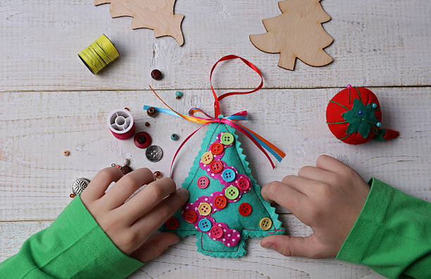 istock Child making felt Christmas Tree decoration ornament 625784068