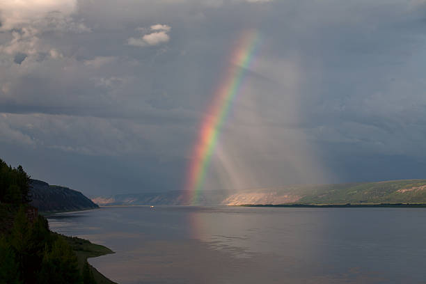 istock The bright rainbow over the big river. 625784228