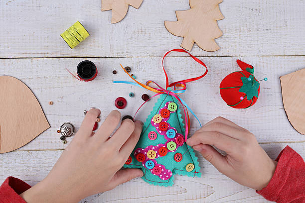 istock Child making felt Christmas Tree decoration ornament 625785572