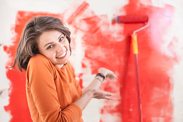 istock Smiling young woman making home imprevement alone 625793024