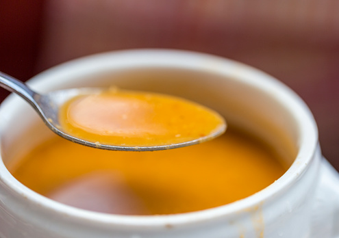 A bowl of delicious orange lentil soup.