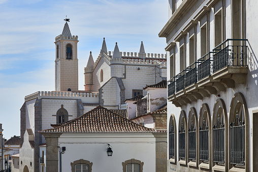 Bell tower of Igreja de Sao Francisco church. View from Rua da Republica. Evora, Portugal.