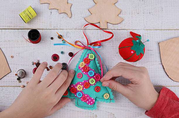istock Child making felt Christmas Tree decoration ornament 625794242