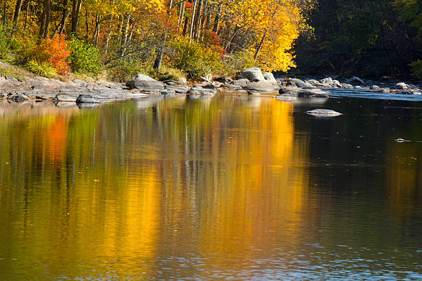 istock Vivid fall foliage reflects on the Farmington River, Canton, Con 625800252