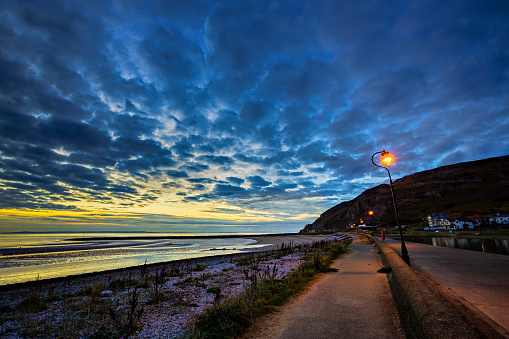 The West Shore beach in Llandudno, North Wales at sunset.