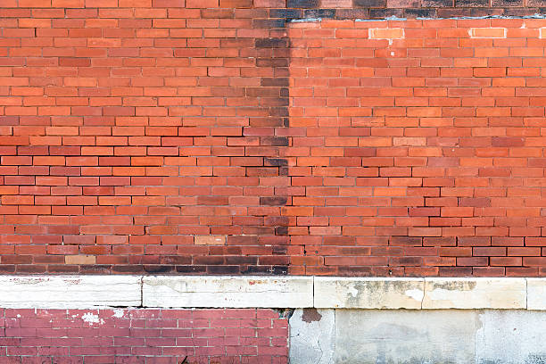 istock Old Exterior Orange Brick Wall with Concrete 625802534