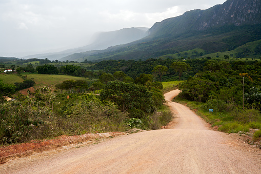Rural dirt road with mountain on background