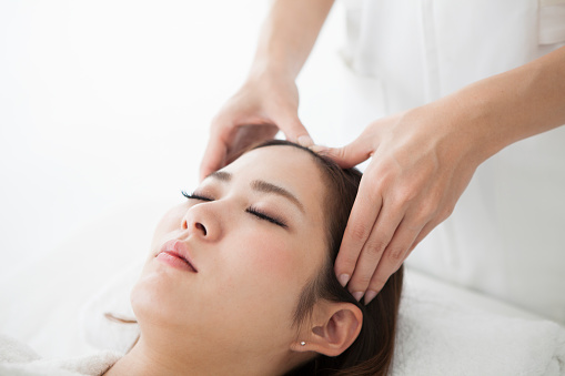 Woman having a head massage at a salon