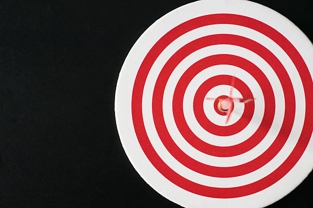 istock Red bullseye dart with red arrow hit center 625812774