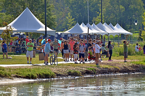 Denver, CO, USA - July 31, 2016: Over 110,000 people attended the 16th Annual Colorado Dragon Boat Festival and enjoyed the exciting dragon boat races as well as all the numerous demonstrations, vendors and delicious foods. Spectators watching the boat races from the shore. 