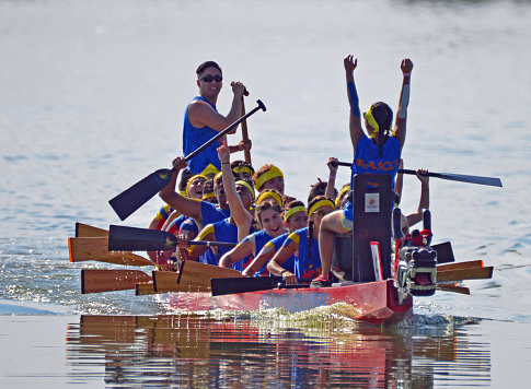 Denver, CO, USA - July 31, 2016: Over 110,000 people attended the 16th Annual Colorado Dragon Boat Festival and enjoyed the exciting dragon boat races as well as all the numerous demonstrations, vendors and delicious foods. Unidentified team competing in the exciting boat races raise their hands in victory. 