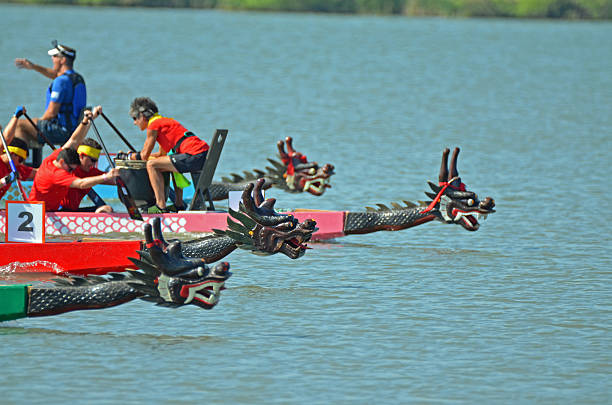 Denver, CO, USA - July 30, 2016: Over 110,000 people attended the 16th Annual Colorado Dragon Boat Festival and enjoyed the exciting dragon boat races as well as all the numerous demonstrations, vendors and delicious foods. Unidentified teams competing in the exciting boat races. The boats all have dragon heads at the front of the boat. 