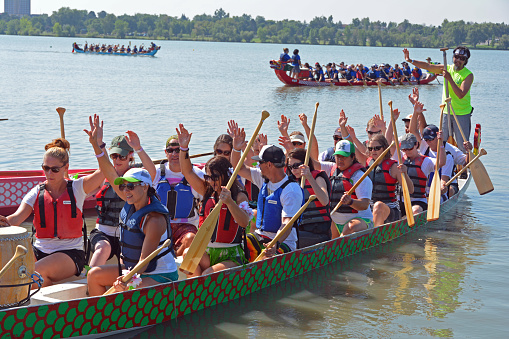 Denver, CO, USA - July 30, 2016: Over 110,000 people attended the 16th Annual Colorado Dragon Boat Festival and enjoyed the exciting dragon boat races as well as all the numerous demonstrations, vendors and delicious foods. Unidentified team waving after competing in the exciting boat races.