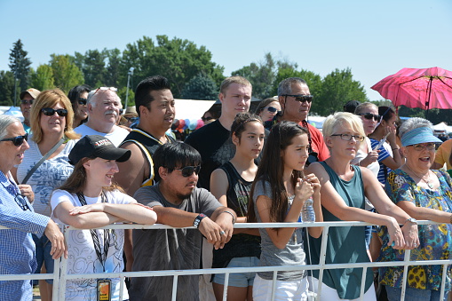 Denver, CO, USA - July 30, 2016: Over 110,000 people attended the 16th Annual Colorado Dragon Boat Festival and enjoyed the exciting dragon boat races as well as all the numerous demonstrations, vendors and delicious foods. Unidentified spectators watching the dragon boat festival.