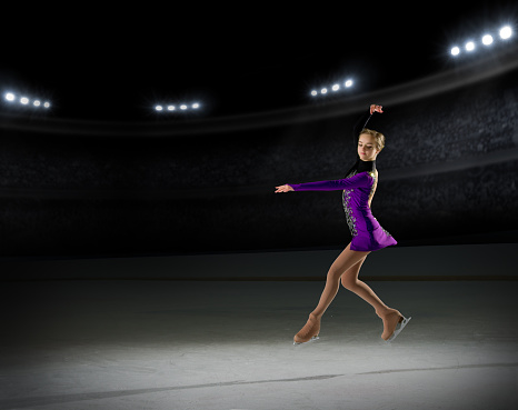 Young girl figure skater (on ice arena with spotlights ver)