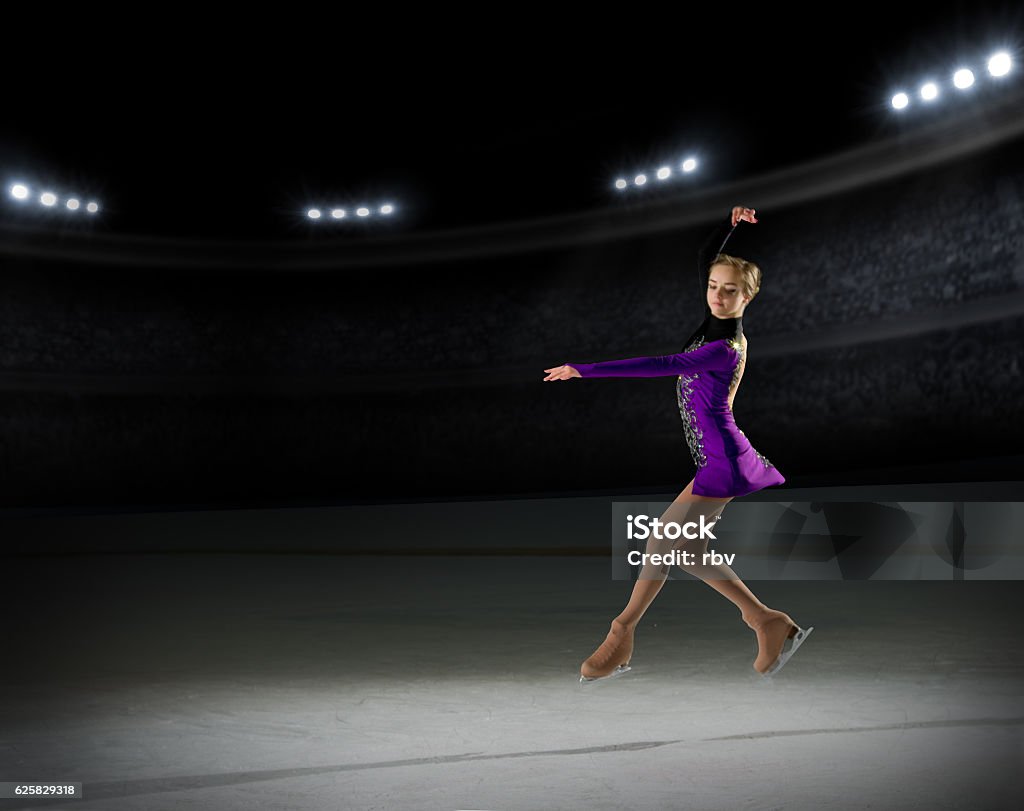 Young girl figure skater Young girl figure skater (on ice arena with spotlights ver) Ice-skating Stock Photo