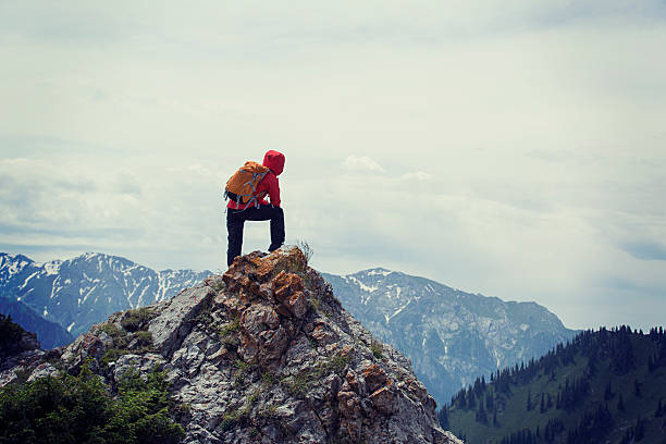 istock successful woman backpacker enjoy the view on mountain peak 625829338