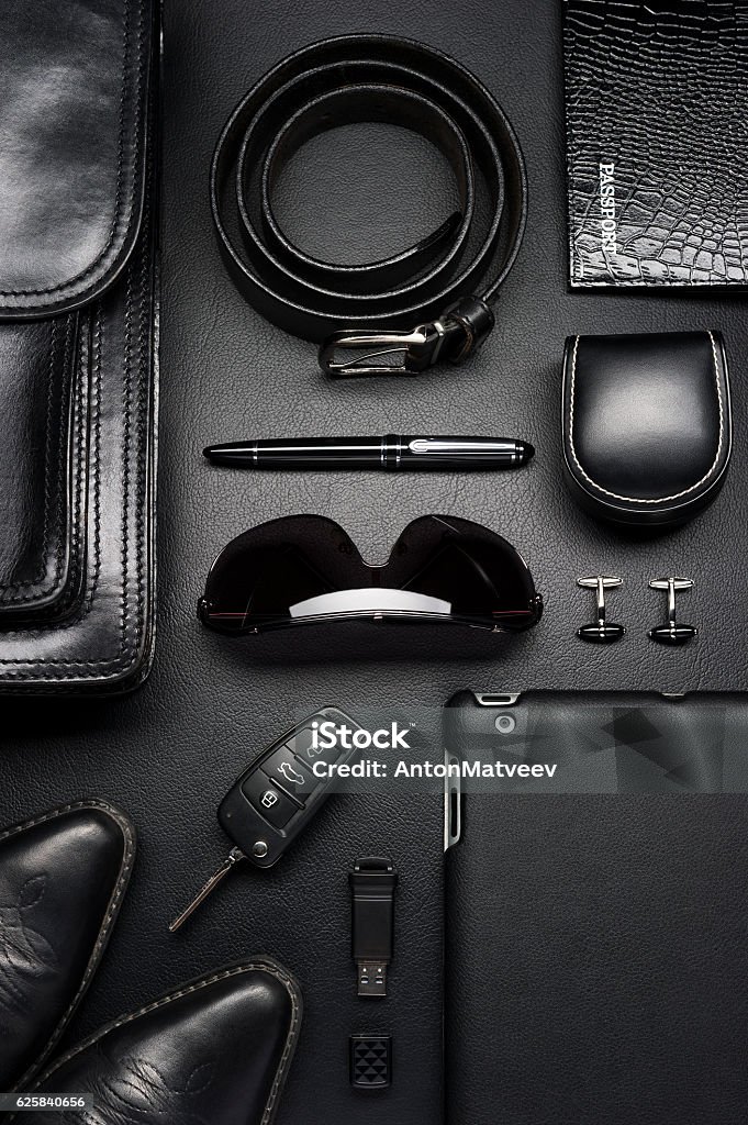 Business man accessories Man accessories in business style, briefcase, gadgets, shoes, clothes and other luxury businessman attributes on leather black background, fashion industry, top view  Personal Accessory Stock Photo