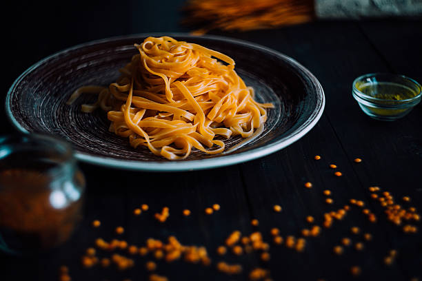 Pasta tagliatelle with seasonic on a wooden table stock photo