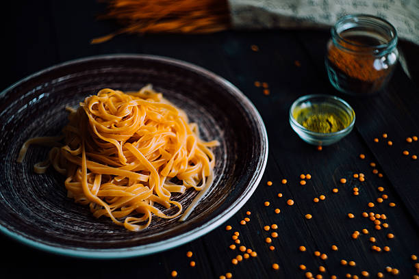 Pasta tagliatelle with seasonic on a wooden table stock photo
