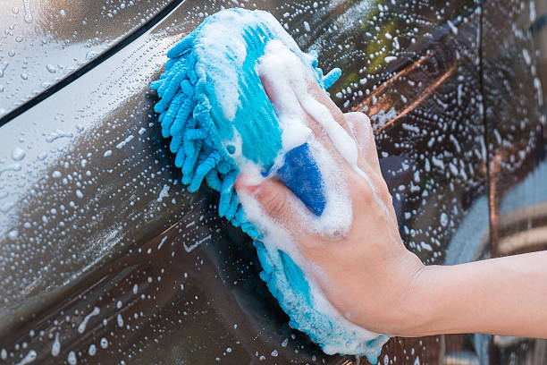 hand washing brown car with blue sponge and bubbles (foam) - male beauty imagens e fotografias de stock