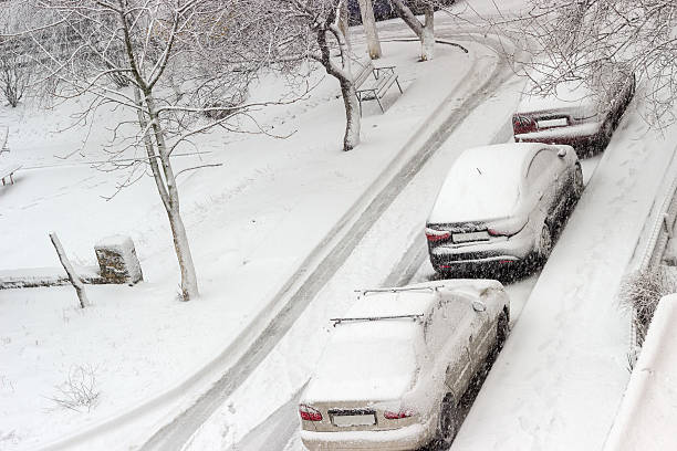 istock Three parked one after another cars during snowfall 625859538