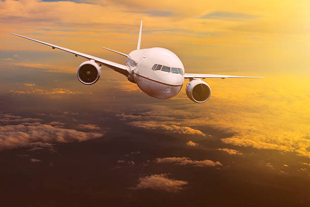 istock traveling plane flying over  sun rising sky 625864276