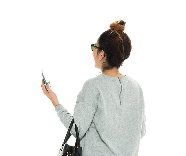 istock Rear view of woman using phone 625872180